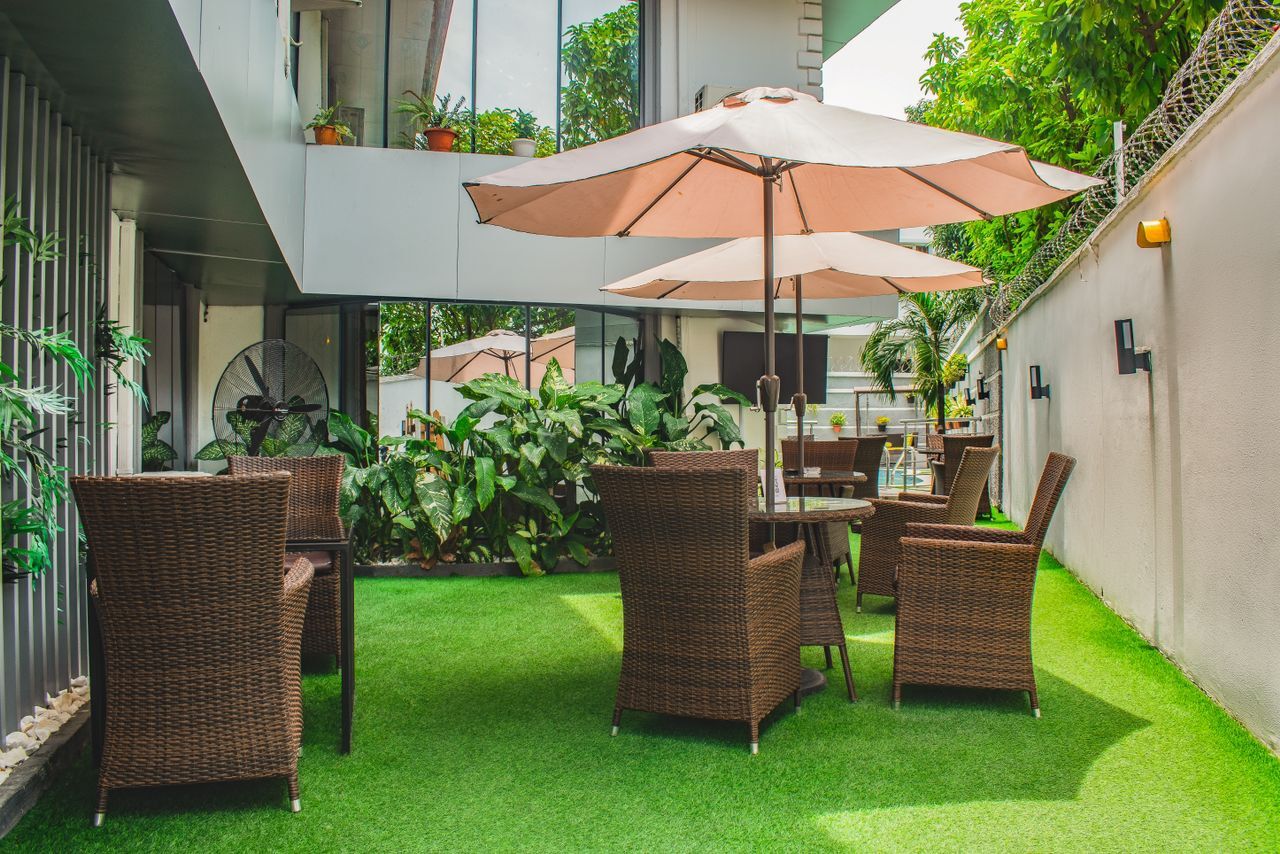 Outdoor terrace with parasols and rattan seating