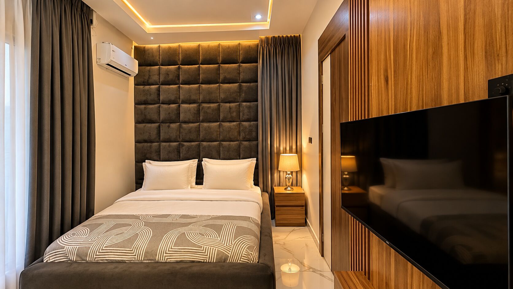 Standard Room with padded headboard, timber wall and bedside lamps
