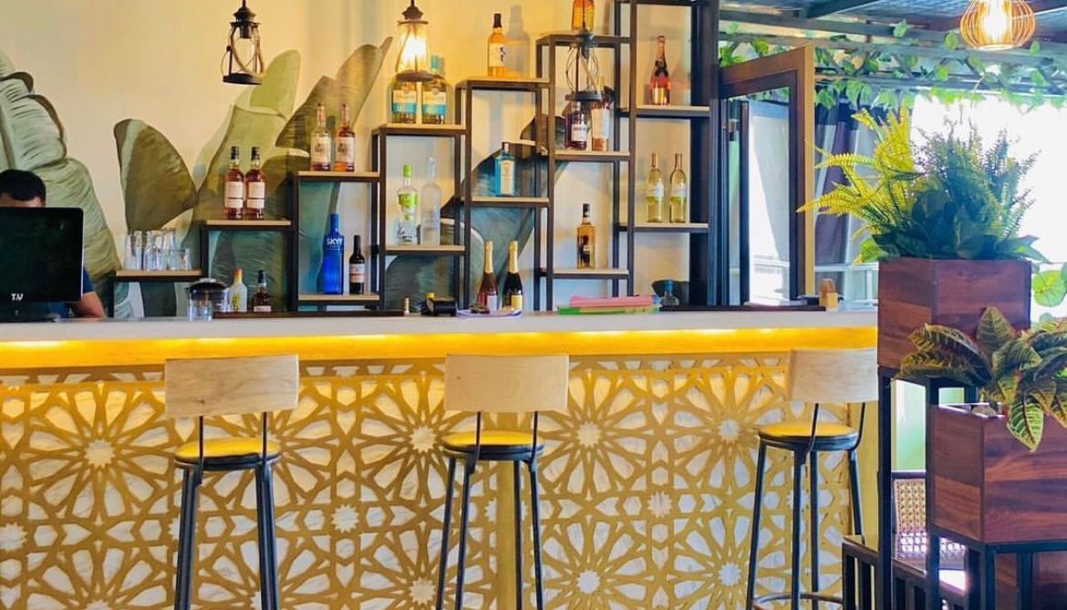 The bar with gold fretwork counter and backlit shelves